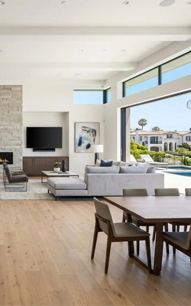 modern open-concept living room with large windows, natural light, and seamless indoor-outdoor design